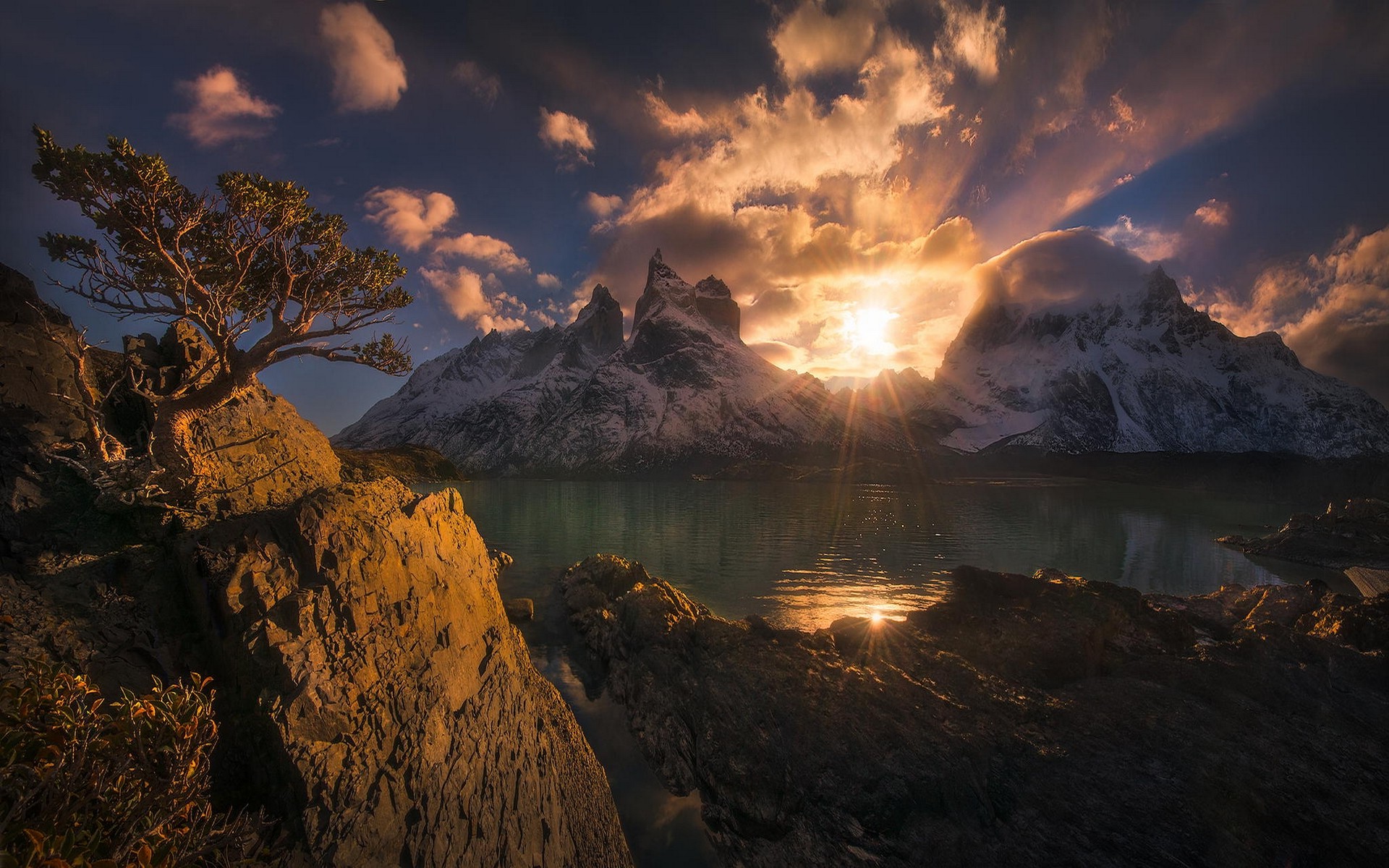 237210 nature landscape mountain sunset Chile Torres_del_Paine lake clouds snowy_peak trees water sun_rays
