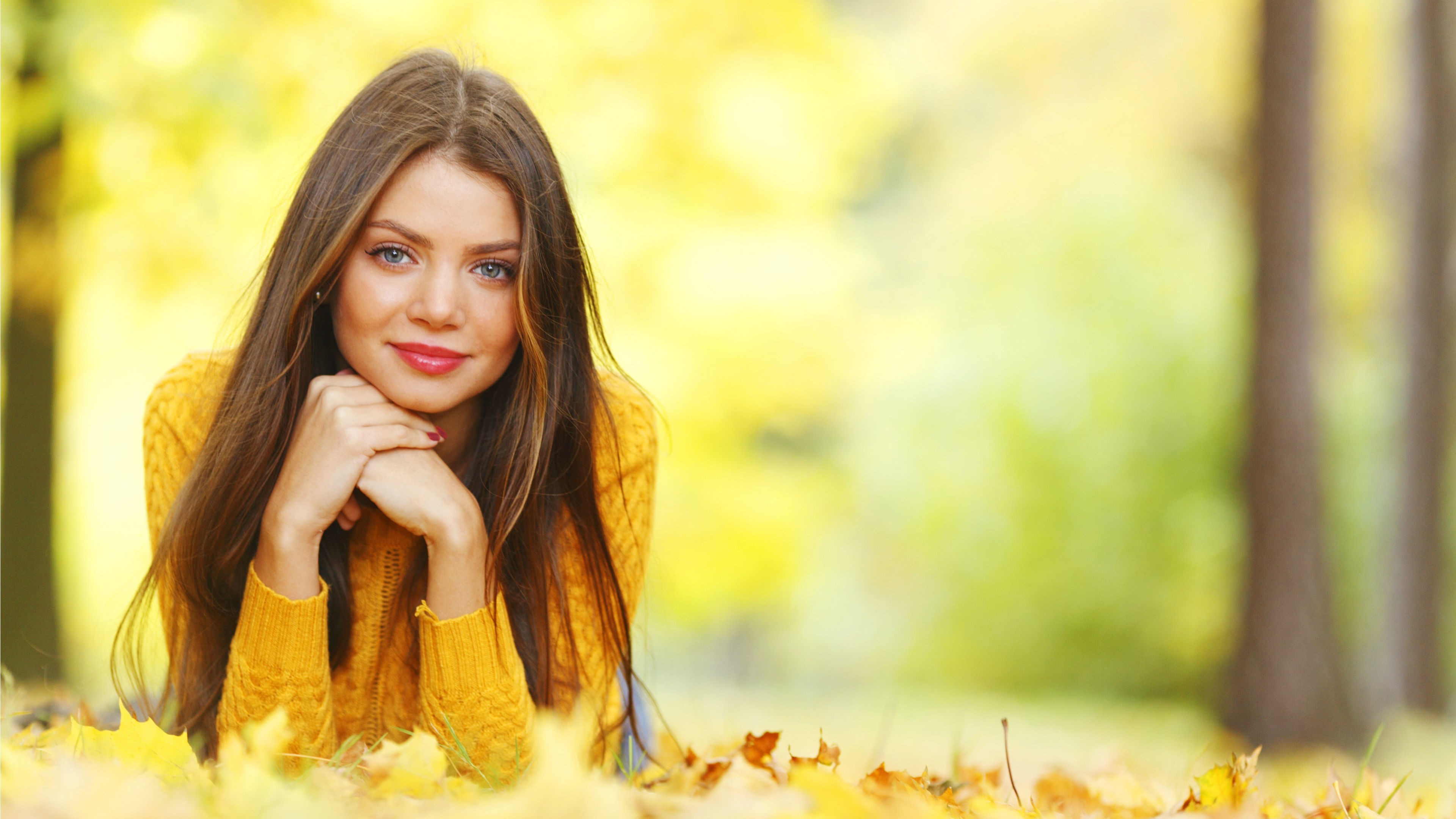 women, Model, Brunette, Long Hair, Women Outdoors, Nature, Face, Portrait, Trees, Smiling, Blue Eyes, Red Lipstick, Sweater, Leaves, Fall, Depth Of Field, Lying On Front, Looking At Viewer Wallpaper