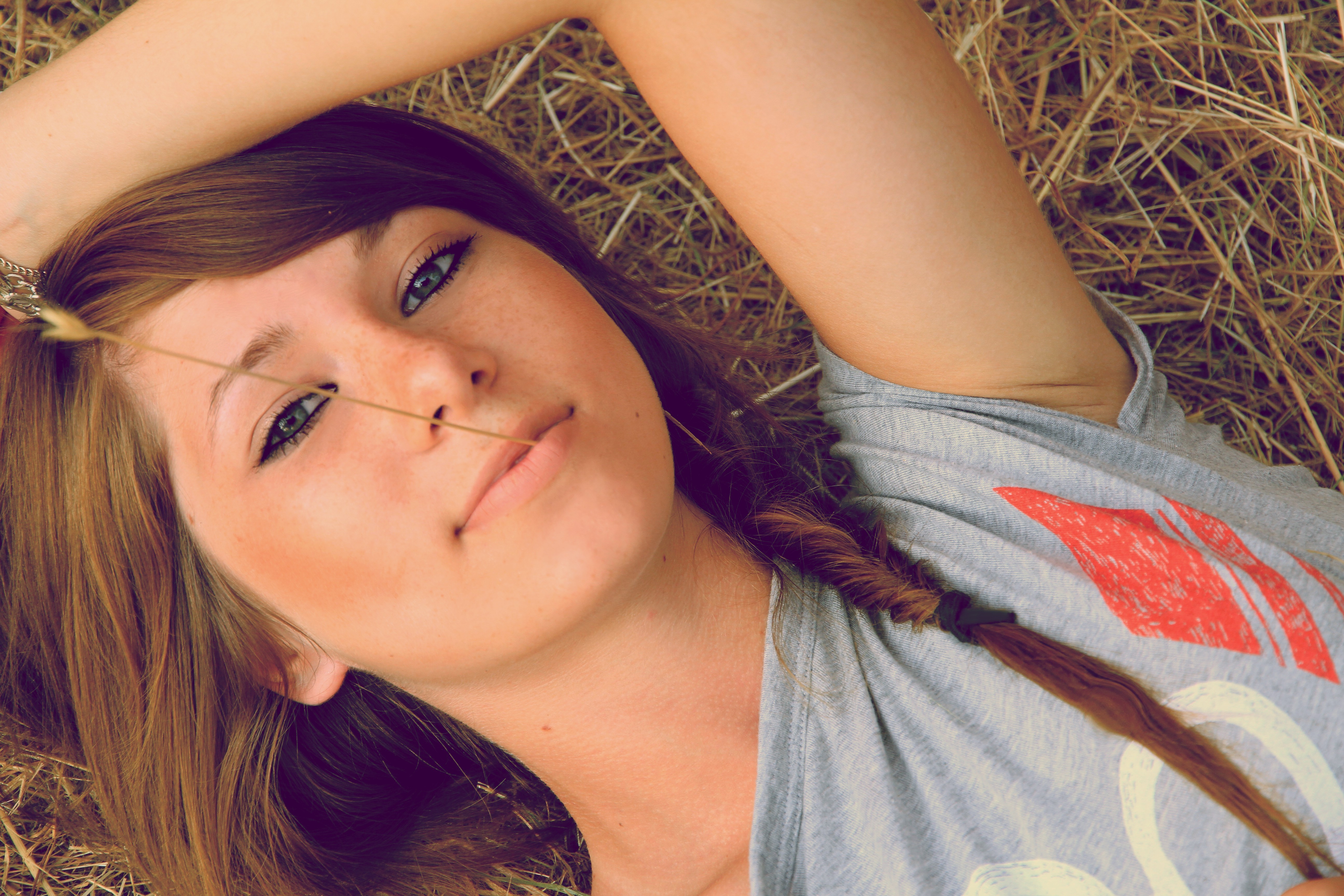 women, Model, Brunette, Long Hair, Women Outdoors, Nature, Face, Portrait, Lying On Back, Looking At Viewer, Spikelets, Straw, Freckles, Hands On Head, T shirt, Smiling, Braids Wallpaper