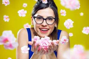 women, Model, Brunette, Long Hair, Looking At Viewer, Face, Portrait, Open Mouth, Smiling, Women With Glasses, Glasses, Flowers, Yellow Background, Tank Top, Bare Shoulders