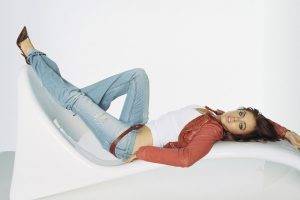 women, Actress, Brunette, Long Hair, Looking At Viewer, Open Mouth, Lindsay Lohan, Lying On Back, Blue Eyes, White Background, Jeans, High Heels, Belt, Leather Jackets, Torn Jeans, Couch
