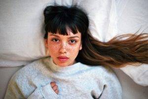 women, Emily Bador, Looking At Viewer, Freckles, In Bed, Lying On Back, Nose Rings, Sweater