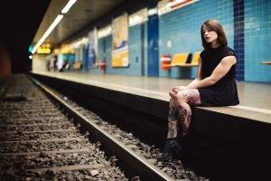 subway train station women tattoo brunette sitting black dress dress