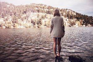 women outdoors lake hill sweater dress barefoot ripples back blonde