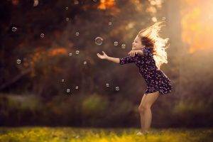 children bubbles smiling little girl jake olson sunlight depth of field nebraska