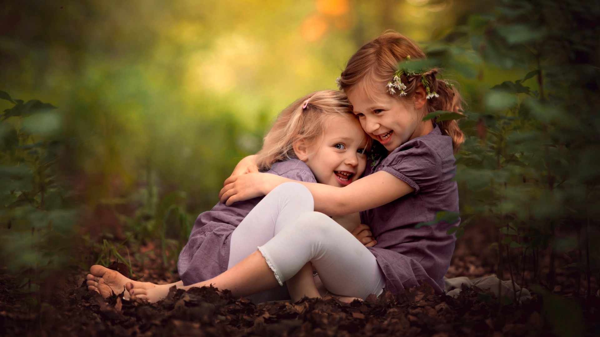 little girl children hugging smiling depth of field Wallpaper
