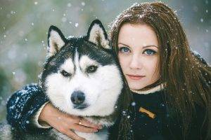 hugging green eyes dog women outdoors snow
