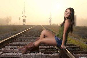 women model sitting boots jean shorts rail yard smiling shorts railway