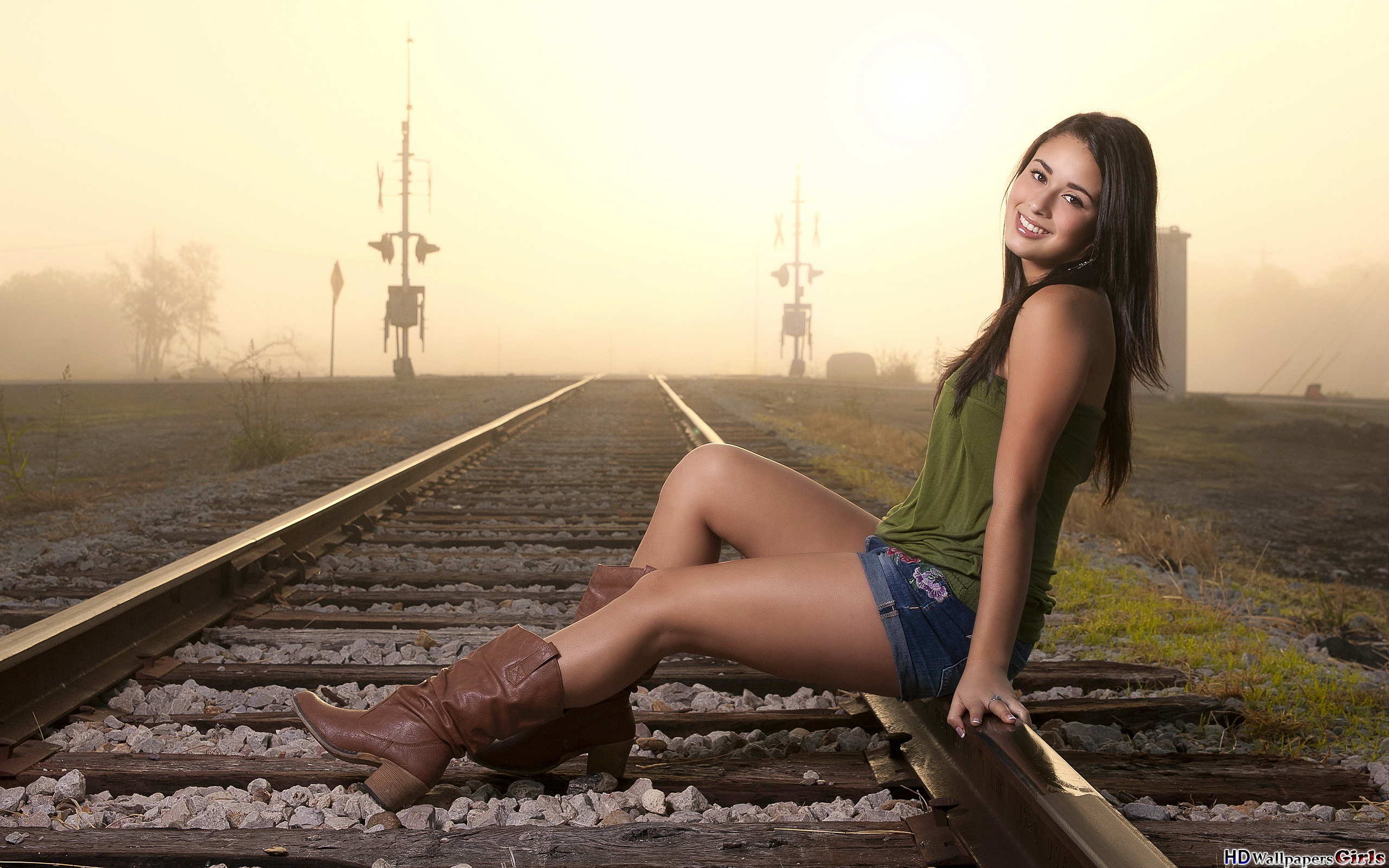 women model sitting boots jean shorts rail yard smiling shorts railway Wallpaper
