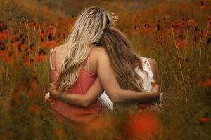 women model long hair blonde brunette women outdoors flowers hugging