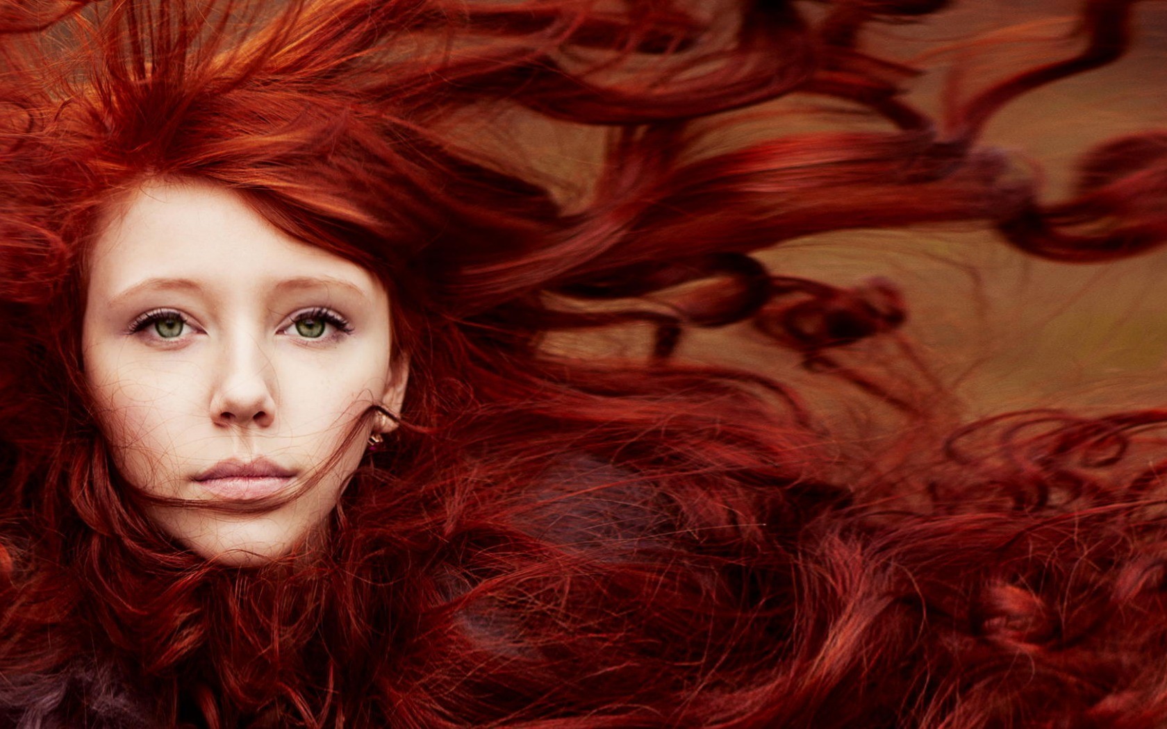 women model redhead face portrait long hair green eyes hair in face windy Wallpaper