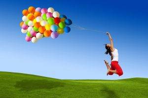 women model landscape nature balloons smiling jumping field grass sky colorful barefoot shadow