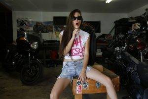 women brunette jean shorts lollipop white tops sunglasses garages