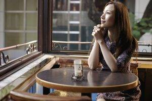 women model long hair asian brunette smiling sitting table cafeteria window