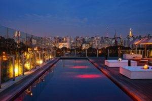 cityscape, City, Architecture, Night, Building, Skyscraper, Lights, Street light, Clouds, São paulo, Brasil, Swimming pool, Hotels, Wooden surface, Deck chairs, Table, Parasol, Tower, Reflection, Luxury
