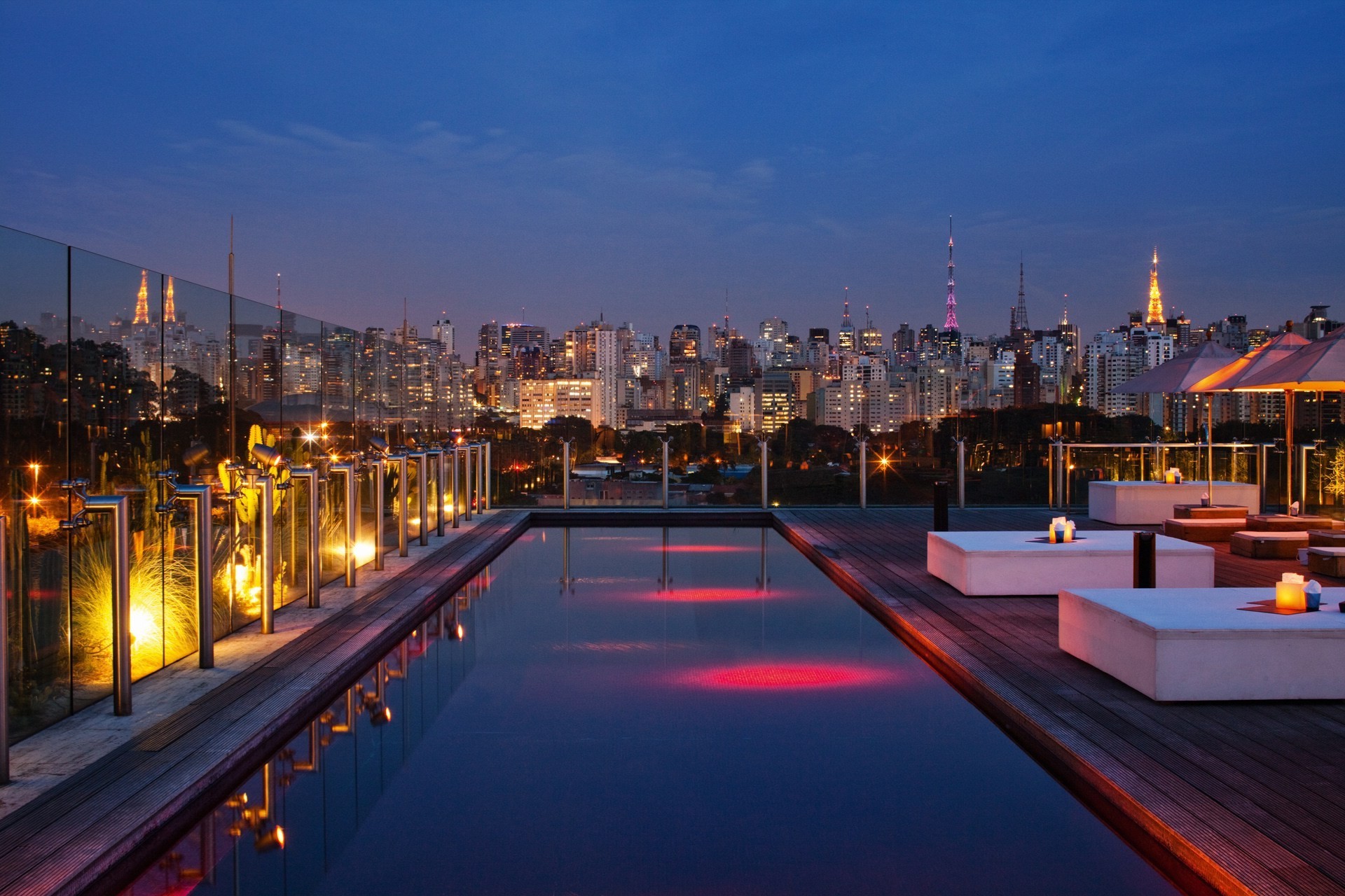 cityscape, City, Architecture, Night, Building, Skyscraper, Lights, Street light, Clouds, São paulo, Brasil, Swimming pool, Hotels, Wooden surface, Deck chairs, Table, Parasol, Tower, Reflection, Luxury Wallpaper