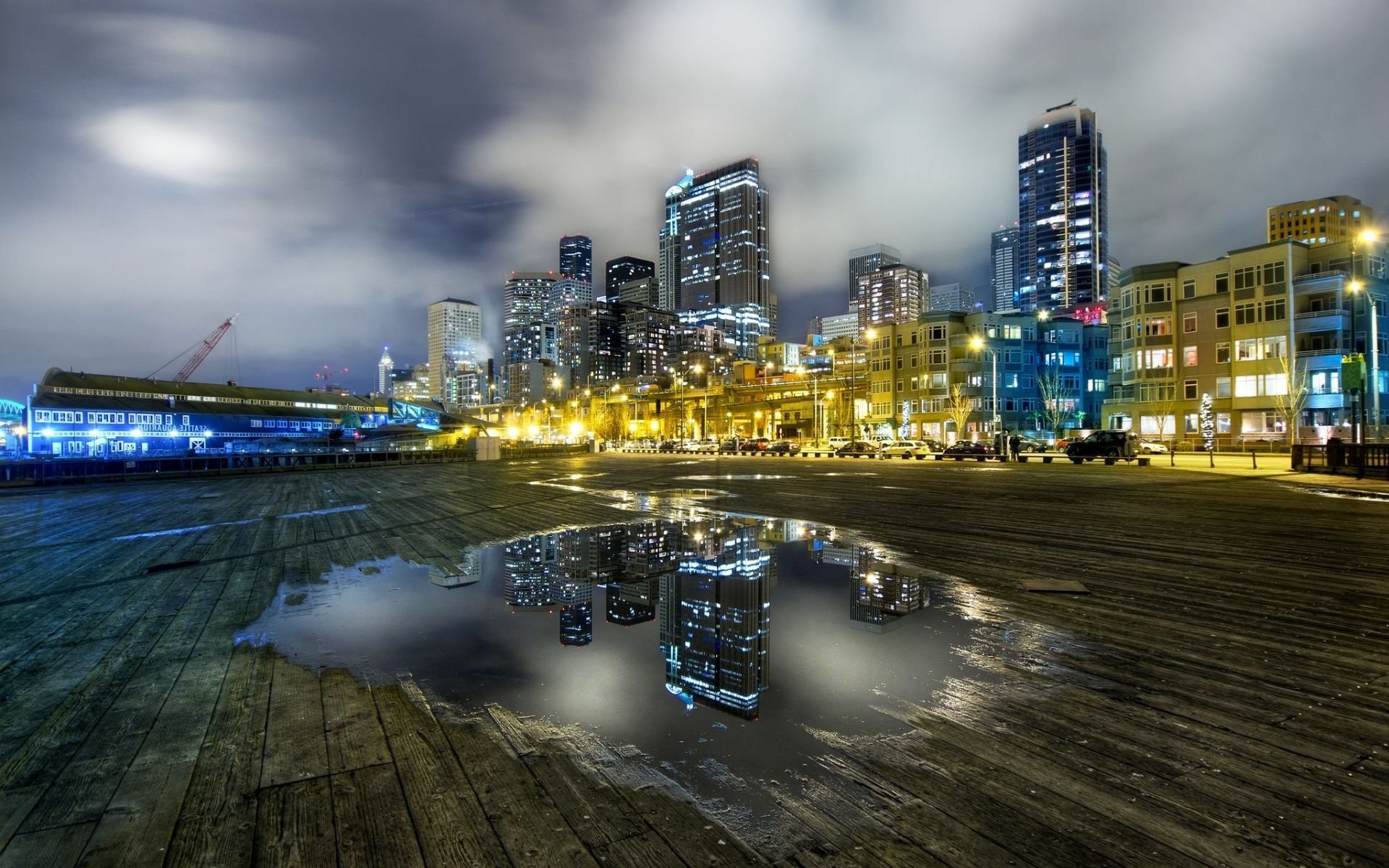 city, Cityscape, Architecture, Modern, Building, Skyscraper, Night, Lights, Sky, Clouds, Long exposure, Seattle, USA, Water, Puddle, Cranes (machine), Wooden surface, Street, Reflection Wallpaper