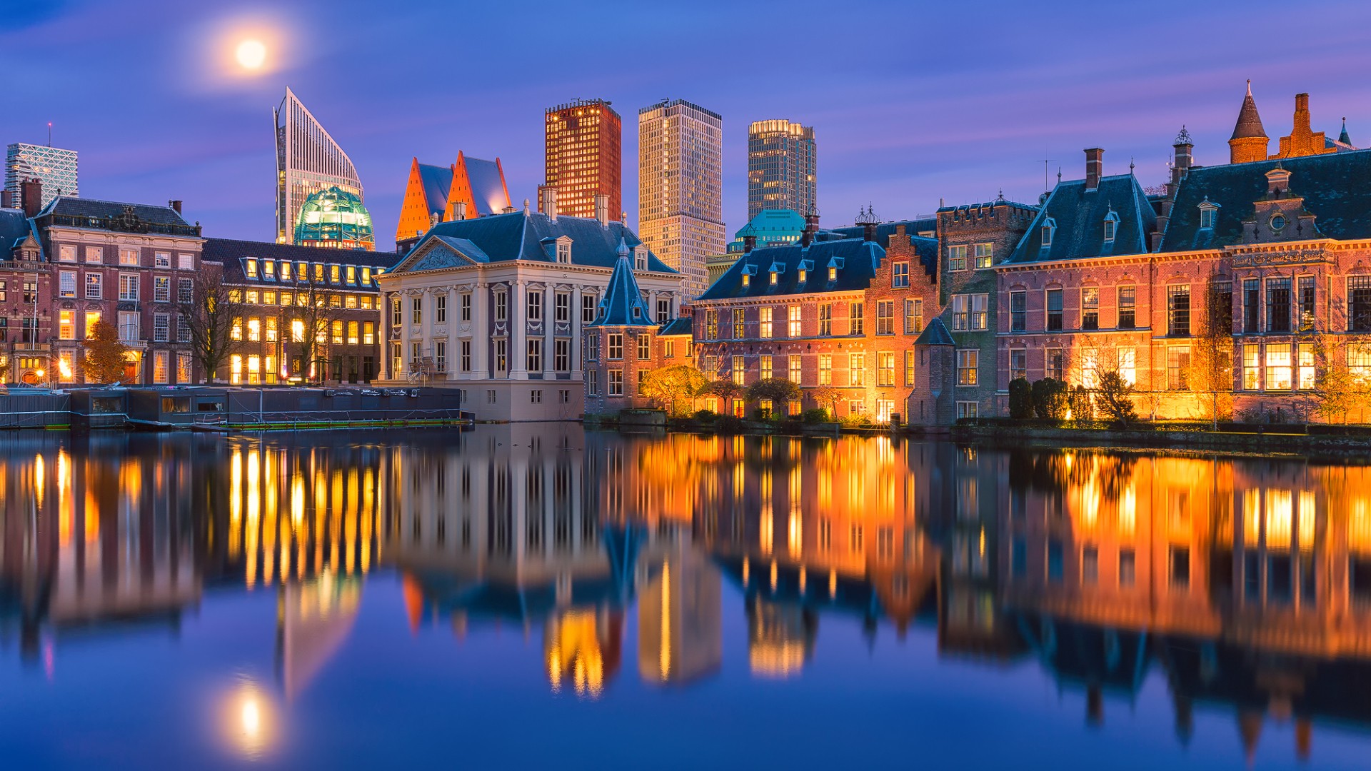 architecture, Building, City, Cityscape, Haag, Netherlands, River, Water, Reflection, House, Old building, Night, Evening, Lights, Trees, Skyscraper, Moon, Moonlight, Clouds Wallpaper