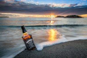 nature, Landscape, Sea, Coast, Bottles, Whiskey, Jack Daniels, Sunrise, Waves, Clouds, Rock, Island, Beach, Sand, Reflection, Horizon