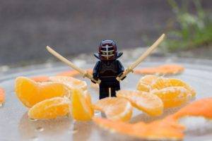 LEGO, Toys, Closeup, Miniatures, Humor, Photography, Depth of field, Ninja, Katana, Fruit, Tangerine, Glass