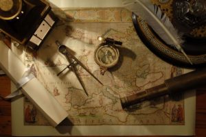 compass, Map, Tools, Feathers, Scrolls, Telescope, Wooden surface