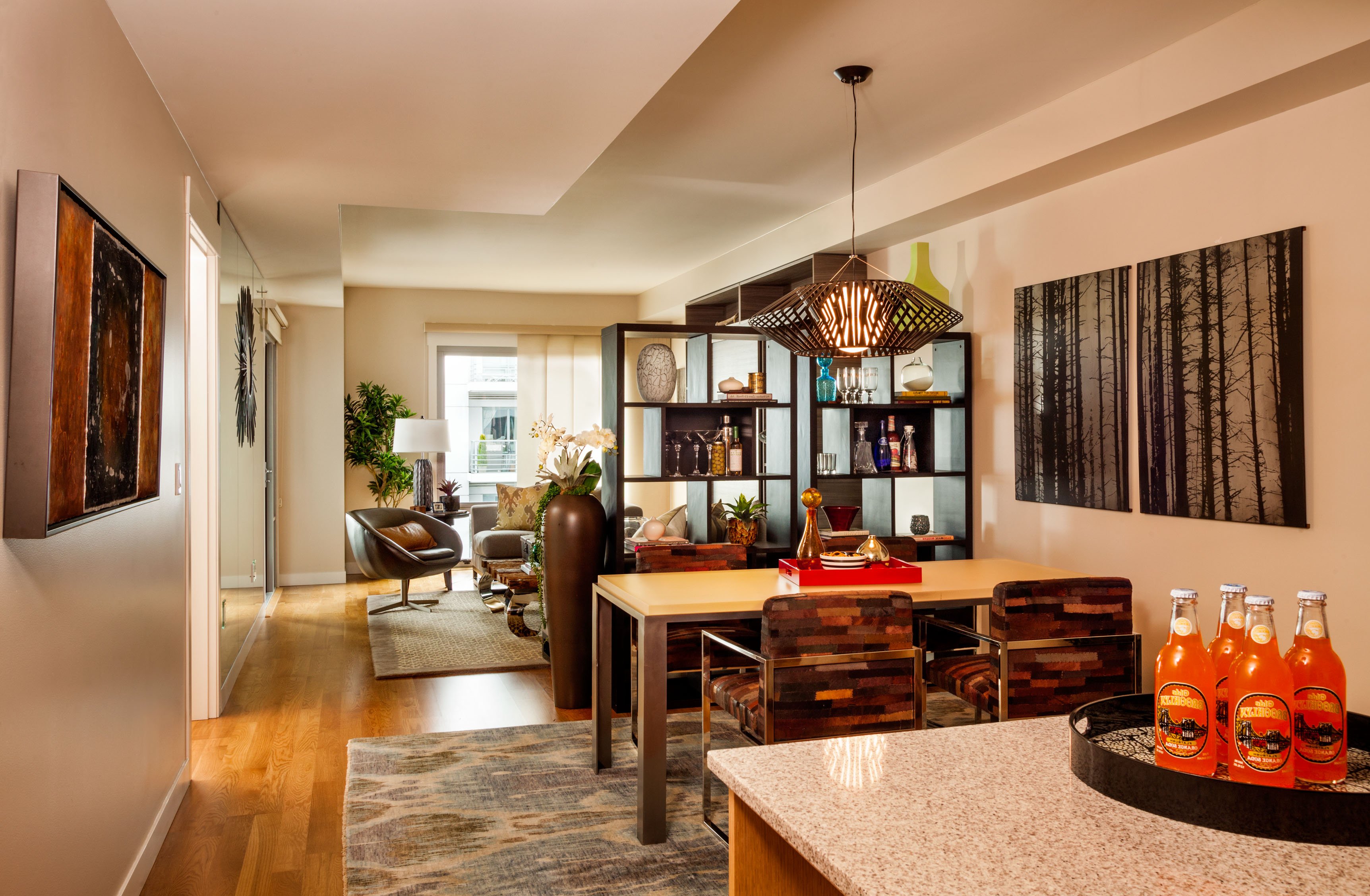 Small living room in a condo with black leather sofa and wood coffee table