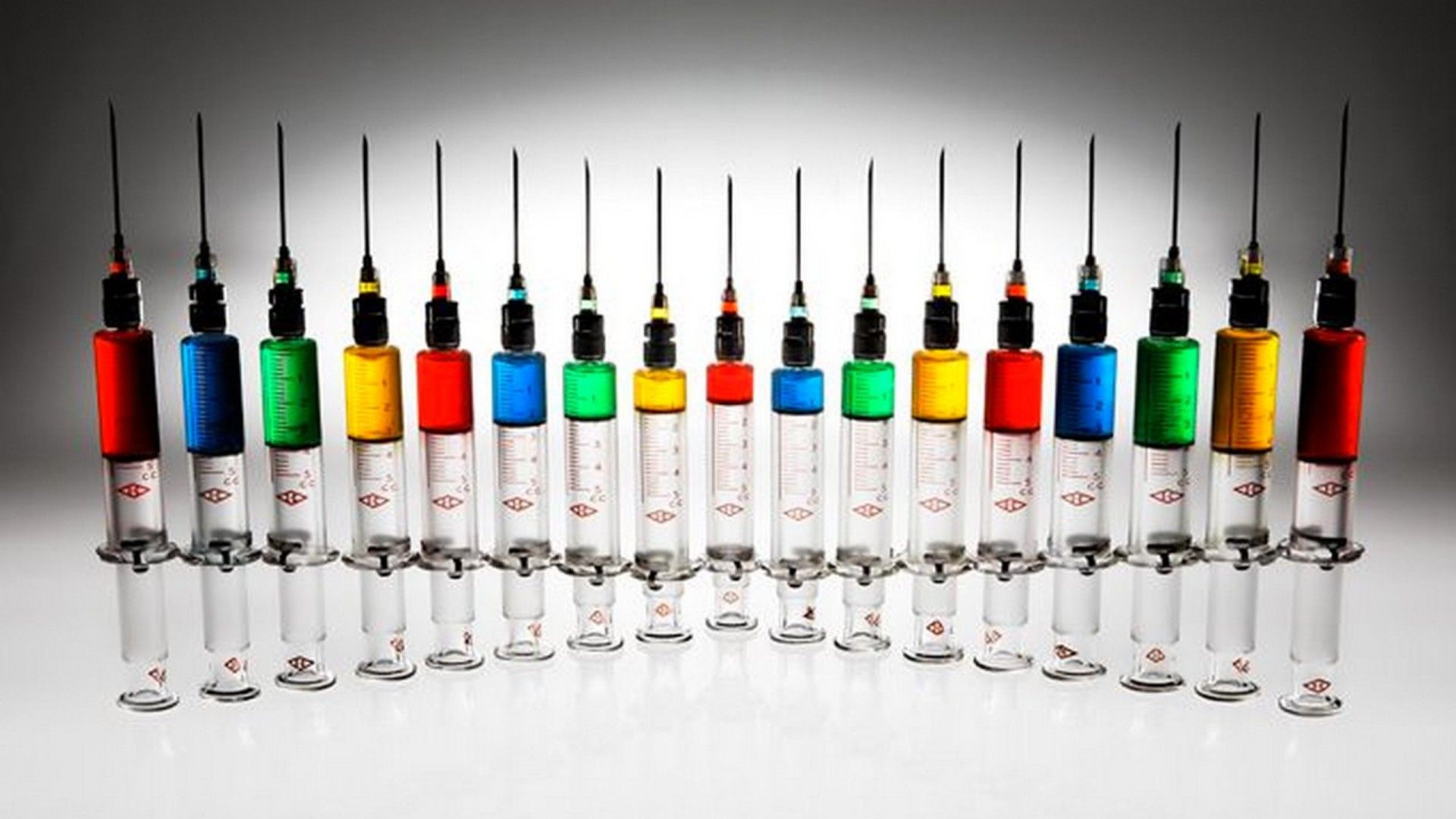 syringes with colored paint Wallpaper